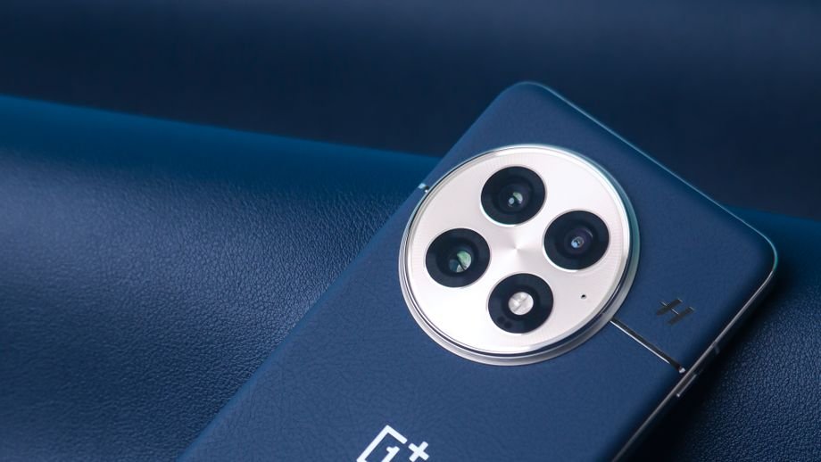 A stylish smartphone with three cameras on a textured blue leather surface.