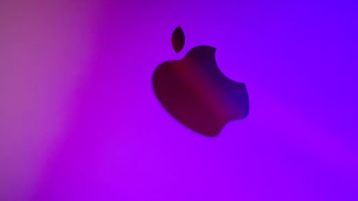 A vibrant abstract image featuring a silhouette of an apple against a purple background.