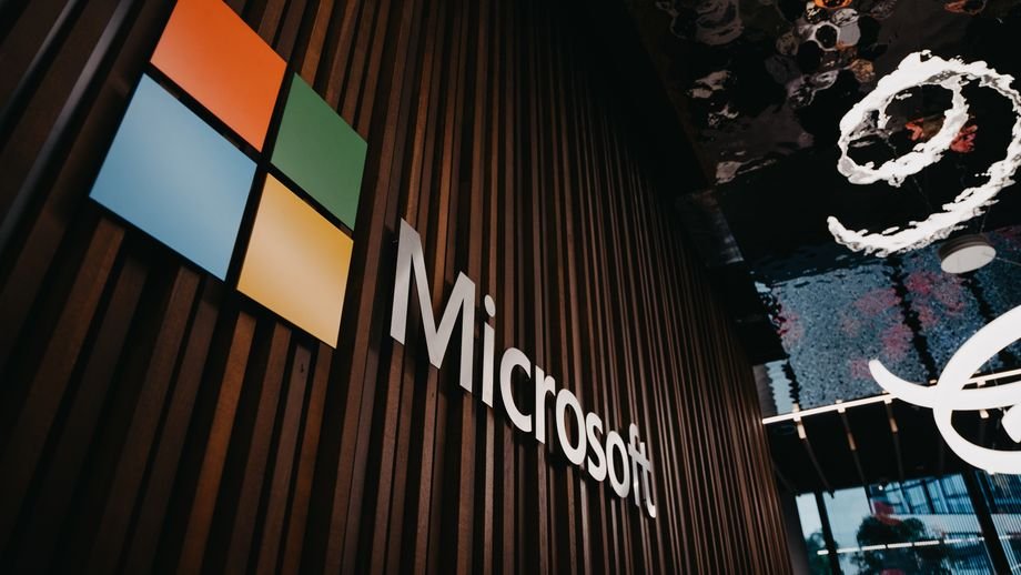 Interior view of Microsoft office with logo on wooden wall in Brussels, Belgium.